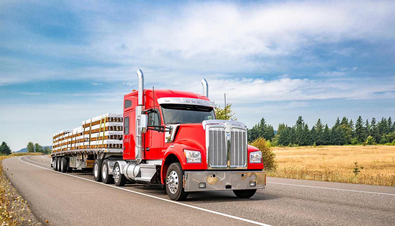 Long trailer carrying construction materials