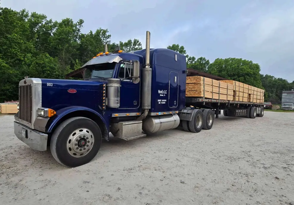 Freight truck with long trailer in forested area